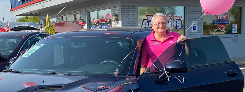 Mary Jones, Account Representative at Car-Mart of Claremore, standing on the lot by a car