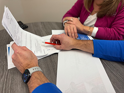 Close up of Car-Mart Associates sitting at table looking at paper work