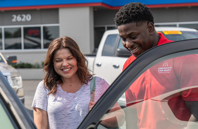 Car-Mart associate assisting customer purchasing a new vehicle